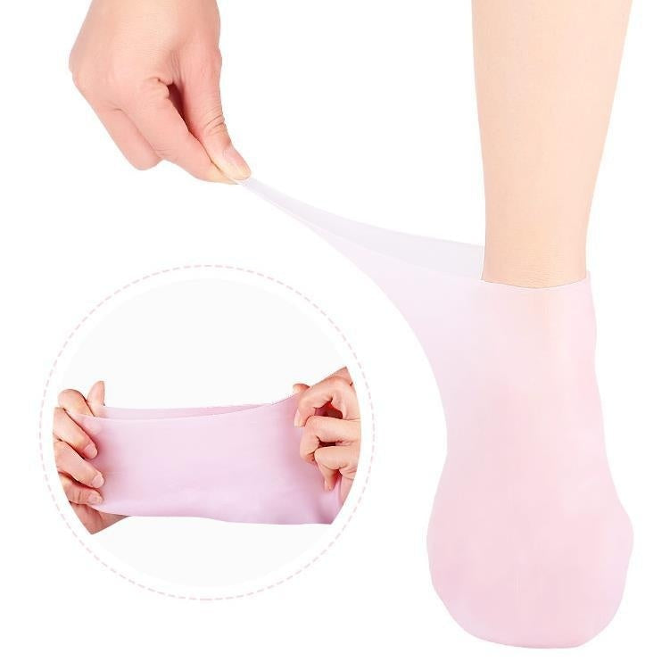 Gel socks for moisturizing and healing cracked heels, shown in soft pink with stretchable silicone material for indoor foot care use.